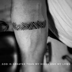 a black and white photo of a man's arm with the words god is greater than my highs and my lows