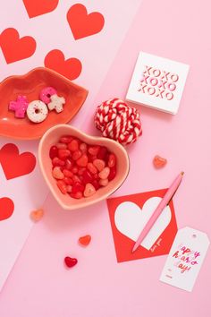 valentine's day treats are arranged on a pink surface