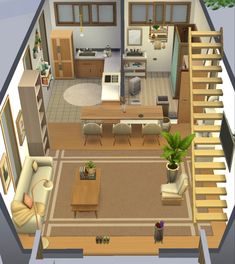 an aerial view of a living room and dining area in a small house with stairs leading up to the second floor