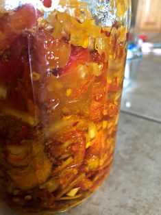 a jar filled with food sitting on top of a counter