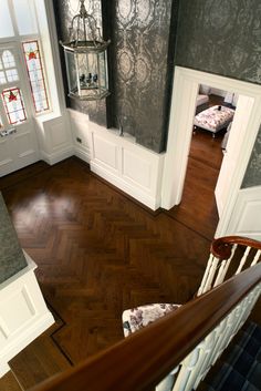 an aerial view of a house with wood floors and white trim on the door, windows, and stairs