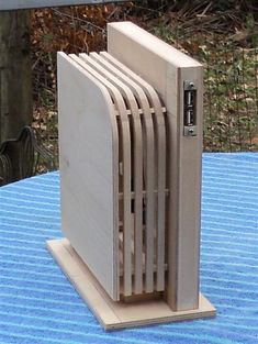 a wooden computer tower sitting on top of a blue table