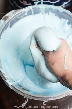 a person is mixing something blue in a bowl