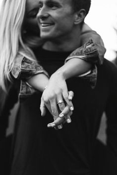 black and white photograph of a man holding a woman