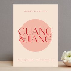 a card with the words guang & jiang on it next to a flower