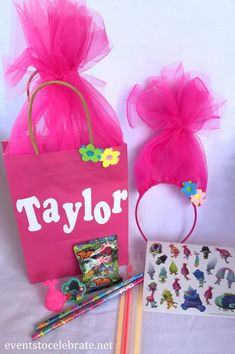 a pink bag and some pencils on a table