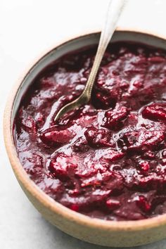 a bowl filled with cranberry sauce and a spoon