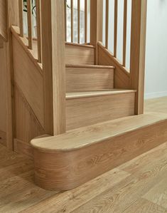 a wooden stair case next to a set of stairs