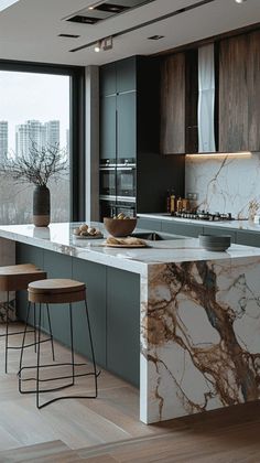 a kitchen with marble counter tops and stools in front of a large window overlooking the city