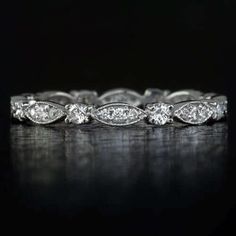 a white gold wedding band with pear shaped diamonds