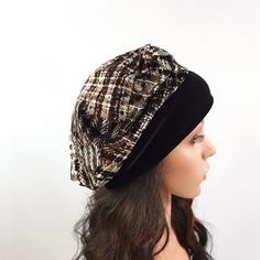 a mannequin head wearing a black and white hat with a plaid pattern on it