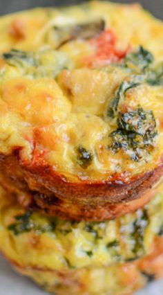 three small muffins stacked on top of each other with cheese and spinach