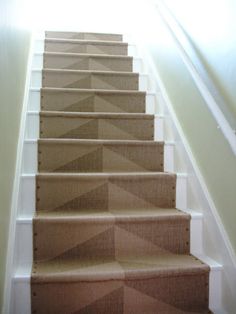 a staircase with carpeted steps leading up to the top