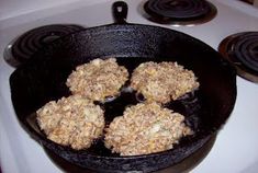 some food is cooking in a black skillet on the stove top and it's ready to be cooked