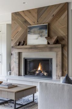 a living room filled with furniture and a fire place in the middle of it's wall