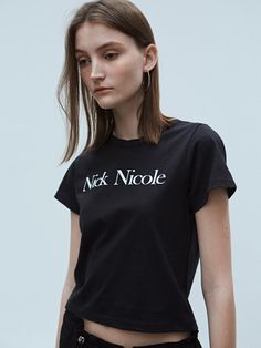 This T-shirt from NICK&NICOLE is accentuated with the signature Nick Nicole logo on the front, making it a standout piece.- Designed for both standalone and layered styling- Offering a soft touch for comfortable wear- Length and thickness that are suitable for seasonless wear Logo Crew Neck Top With Relaxed Fit, Relaxed Fit Logo Top With Crew Neck, Fitted Logo Top With Short Sleeves, Relaxed Fit Crew Neck Top With Logo, Fitted Cotton Tops With Logo, Fitted Short Sleeve Tops With Logo, Black Logo Tops For Spring, Logo Fitted Crew Neck Top, Fitted Crew Neck Top With Branding