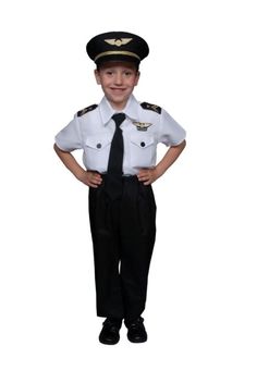 a young boy dressed in a navy uniform posing for the camera with his hands on his hips