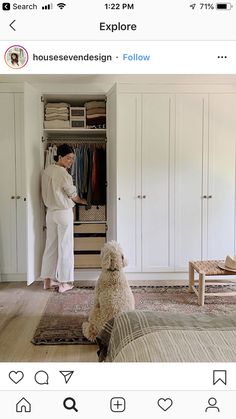 a woman standing in front of a closet with a dog sitting on the floor next to it