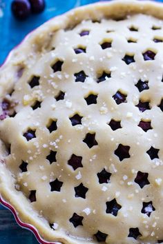 an uncooked pie sitting on top of a blue table