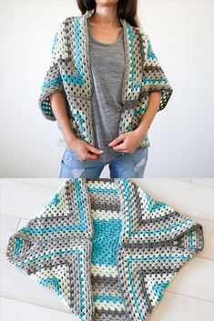 a woman standing next to a crocheted blanket