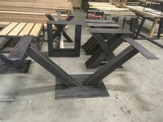 several tables and benches sitting in a warehouse