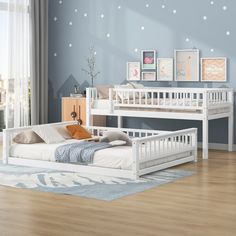 a white bunk bed sitting on top of a wooden floor