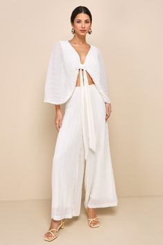 The Lulus Pristine Presence Ivory Plisse High-Waisted Wide-Leg Pants are necessary for creating remarkable resort looks all vacay long! Pleated plisse woven chiffon shapes these breezy pants that feature a high-waisted fit and trendy wide pant legs that fall to full-length hems. Hidden back zipper/clasp. Pair with the matching top for a complete look! Fit: This garment fits true to size. Length: Floor length. Size medium Inseam: 29.25 Front Rise: 13.75 Waist: Fitted - very fitted at natural wais High-waist Wide Leg Pants For Beach Loungewear, White Plisse Set, White Wide-leg Pants Sets For Summer, White Wide-leg Beach Pants, White Wide-leg Rayon Pants, Chiffon Pants, Resort Look, High Waisted Wide Leg Pants, Womens Trendy Dresses