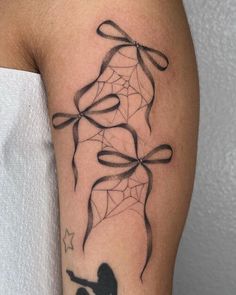 a woman with a spider web tattoo on her arm, holding a knife in the other hand