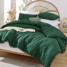 a bed with green comforters and pillows