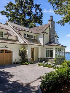 a large white house sitting next to the ocean