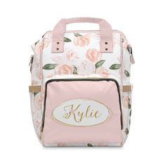 a pink and white floral lunch bag with the name kylie on it's side