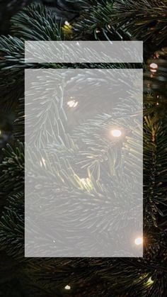 a christmas tree with lights and a square frame on it's bottom half, in front of a black background