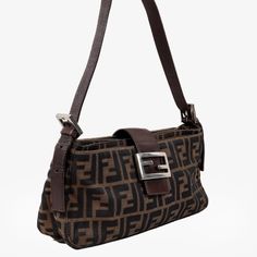 The Mini Fendi Baguette Bag Features Silver Hardware, Leather Straps, And Two Three Pouches Lined With Canvas. The Brown Exterior And Clasp, Which Shows Off The Brand’s Logo, Creates The Iconic Fendi Look. Condition: Excellent; Minor Scratches On Logo Clasp; Slight Discolouration On Interior; Wear On Strap Approximate Measurements Height: 5” (13 Cm) Width: 10.75” (27.5 Cm) Depth: 2.5” (6 Cm) Strap Drop: 9.25” (23.5cm) Composition: Canvas Vintage Baguette Bag, Fendi Baguette Bag, On Logo, Fendi Baguette, Baguette Bag, Silver Hardware, Leather Straps, Fendi, Bag Lady