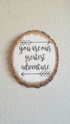 a wooden sign that says you are our greatest adventure