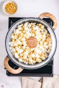 a pan filled with popcorn on top of a stove