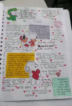 an open notebook with drawings and writing on the pages, including a cartoon dog holding a heart