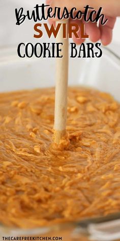 a hand holding a wooden spoon over a cookie bar batter in a glass bowl with the words butterscotch swirl on it