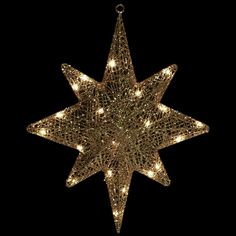 a lighted star ornament hanging from the ceiling