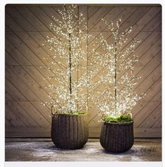 two wicker baskets with white lights in them