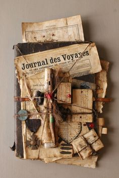 an old book is covered with various items