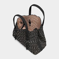 ALAÏA "Mina" mini tote bag in cutout design appliqués leather. Flat top handles loop through sides of bag. Adjustable shoulder strap. Open top. Interior, slip pocket. Leather lining. Feet protect bottom of bag. 7.9"H x 9.8"W x 4.3"D. Made in France. Alaia Mina, Shoulder Strap Bag, Cutout Design, Mini Tote Bag, Perforated Leather, Mini Tote, Pump Sandals, Open Top, Black Tote Bag