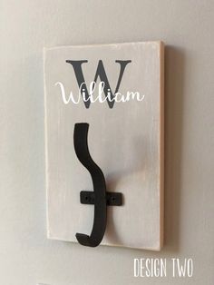 a wooden sign with the letter s on it's side hanging from a wall