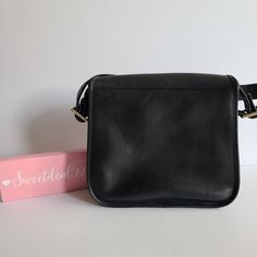 "Vtg Classic Coach NYC Stewardess Bag Navy leather (almost black) with brass hardware Roomy interior with inner zip pocket, outer full slip pocket and a small slip pocket Covered by a flap and secured with a turnlock Original hangtag and chain Adjustable 31\" strap at longest Measures: 11\"L, 11\"H, 3\"W Made in New York, USA #384-3612 Cleaned, conditioned and ready to wear! Questions? Just ask More vtg coach styles/colors also available G144" Classic Black Flap Shoulder Bag, Black Flap Saddle Bag For Formal Occasions, Black Formal Flap Saddle Bag, Classic Flap Bag With Gold-tone Hardware, Classic Office Shoulder Bag With Brass Hardware, Classic Formal Shoulder Bag With Brass Hardware, Classic Satchel Flap Bag With Brass Hardware, Classic Black Flap Bag For Work, Black Business Bags With Brass Hardware