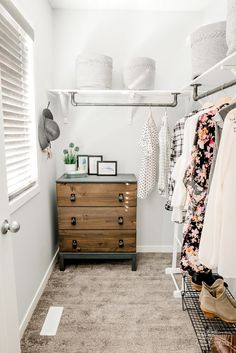 a walk in closet with clothes and shoes hanging on the rails, next to a dresser