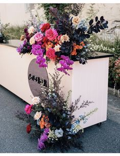 a flower arrangement on top of a white box