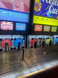 a row of soda machines sitting next to each other