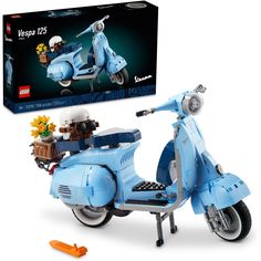 a blue scooter is shown in front of a box with legos on it