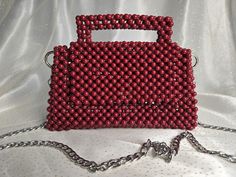 Handmade Dark Red Beaded Bag with Silver-Toned Hardware This elegant handbag, crafted from dark red beads, features silver-toned hardware and a 47-inch removable chain. The magnetic closure adds convenience and ease of use. Our bags are 100% handmade. Each bag is unique and crafted with love for our customers. It takes 3-5 days to create one bag. A perfect gift for women, friend, family member or loved one. Ideal for any celebration, event, wedding or birthday party. This unique and distinctive Red Beaded Rectangular Shoulder Bag, Red Beaded Clutch Evening Bag, Luxury Red Beaded Bag, Elegant Red Beaded Shoulder Bag, Red Beaded Rectangular Evening Bag, Elegant Handbag, Bead Bag, Red Beads, Beaded Bag