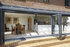 an open kitchen and dining room with sliding glass doors