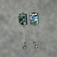 These unique dangling statement earrings are handmade using abalone shell and Czech glass. Perfect gift for any occasion! Free U.S shipping! Anni Designs. The shells of abalones is highly iridescent. The ever changing colors is mesmerizing and mysterious. The dazzling color palette of green, purple, blue and a touch of peach, strikes a balance between extroverted yet peaceful. The length of the earrings is 2 1/4 inches, 56mm. (excluding the length of hook) For matching bracelet, please go to: ht Elegant Iridescent Crystal Earrings Gift, Czech Glass Drop Earrings For Gifts, Silver Abalone Shell Earrings Gift, Handmade Iridescent Dangle Earrings, Dangle Crystal Earrings With Czech Glass For Gift, Czech Glass Crystal Dangle Earrings As Gift, Czech Glass Dangle Crystal Earrings For Gift, Adjustable Dangle Pearl Earrings For Gift, Handmade Iridescent Crystal Earrings As Gift